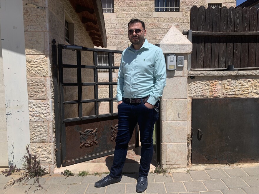 Yehuda Ben Sheetrit, an ultra-Orthodox Jewish Israeli, lost his wife Osnat to COVID-19. He stands outside the new apartment he has moved to with his four children after losing his wife.