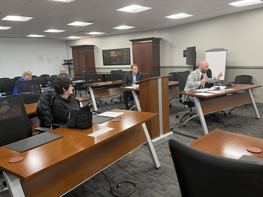 Robert Hanauer (right) presents his objection to Jodi Peine's (left) nominating papers for the Illinois Central College Trustee Board at ICC on Monday, Jan. 9.