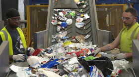 Workers sort recycling at Rumpke's material recovery facility in Cincinnati, Ohio.