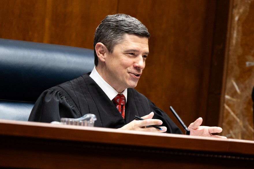 Justice Brett Busby questions Amanda G. Taylor, Butler Snow LLP, during the oral argument for Texas Department of State Health Services, and Dr. Jennifer A. Shuford v. Sky Marketing Corp., D/B/A Hometown Hero; Create a Cig Temple, LLC; Darrell Surif; and David Walden, at the Texas Supreme Court building on Wednesday, January 14, 2026. Patricia Lim/KUT News