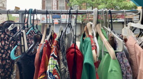 Looking at the racks at the Bed-Stuy Clothing Swap in Brooklyn, New York City.