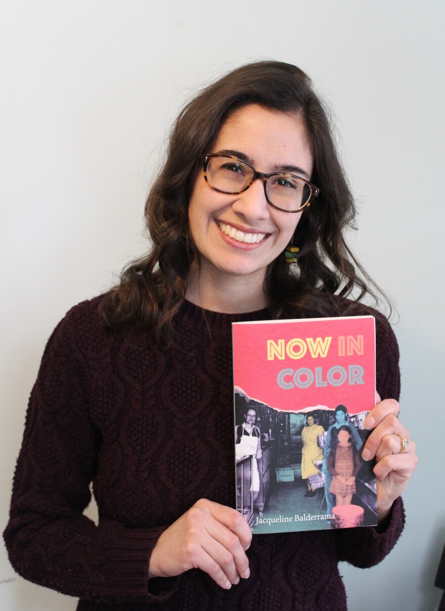 A photo of Jacqueline Balderrama holding her book "Now In Color"