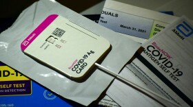 An at-home rapid test shows the person tested positive for COVID-19. IDOH reported nearly 97,000 new cases in the last week.