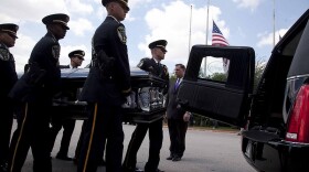 The Honor Guard carries Officer Padron's casket at memorial services on Wednesday.