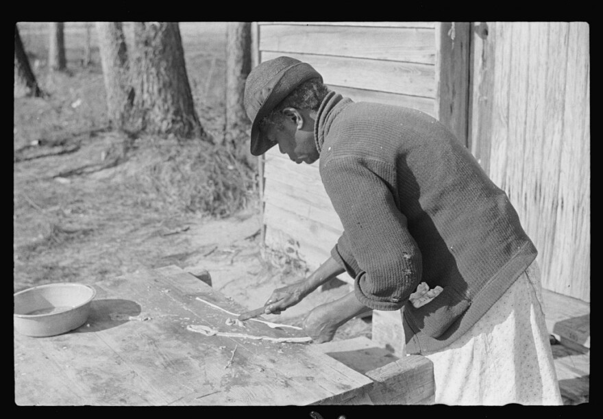 Woman making 'chitlins' after hog-killing. Near Maxton, North Carolina. December 1938