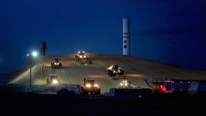 During harvest time, trailer loads of corn arrive at Hoxie Feedyard late into the night. The feed yard will buy more than $20 million worth of corn this year.