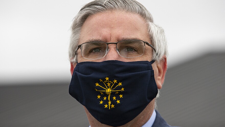 FILE - In this Thursday, April 30, 2020 file photo, Gov. Eric Holcomb wears a mask in Kokomo, Ind.