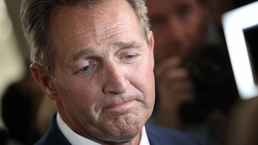 Sen. Jeff Flake, R-Ariz., speaks to reporters after announcing he will not seek re-election in October.