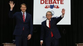 Democratic gubernatorial candidate Richard Cordray, left, and Ohio Attorney General and Republican gubernatorial candidate Mike DeWine wave to the crowd before a debate at Marietta College in Marietta, Ohio, in Oct. 2018. 
