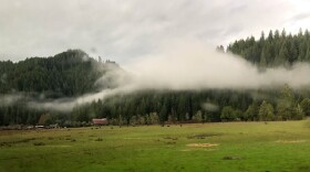 A winter morning in an Oregon valley finds wood smoke trapped in low-hanging cloudcover.