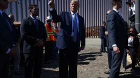 President Trump talks with reporters after touring a section of the southern border wall in September in Otay Mesa, Calif.