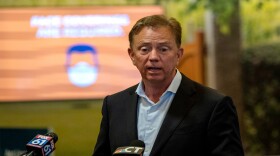Gov. Ned Lamont speaks at Bradley International Airport about new quarantine procedures for travelers coming to Connecticut from some states with high COVID-19 infection rates.