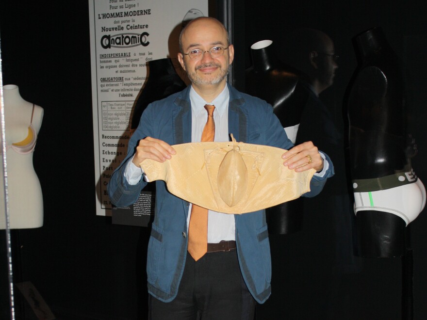 Musée des Arts Décoratifs curator Denis Bruna holds up a reproduction codpiece.