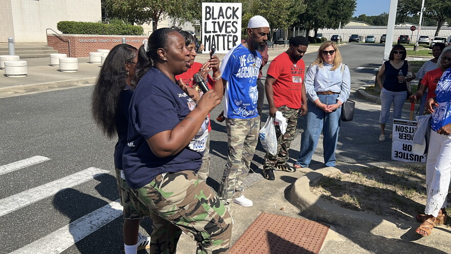 Meka Fortson, mother of Senior Airman Roger Fortson, speaks to supporters outside the Okaloosa County Courthouse Annex Extention in Fort Walton Beach.