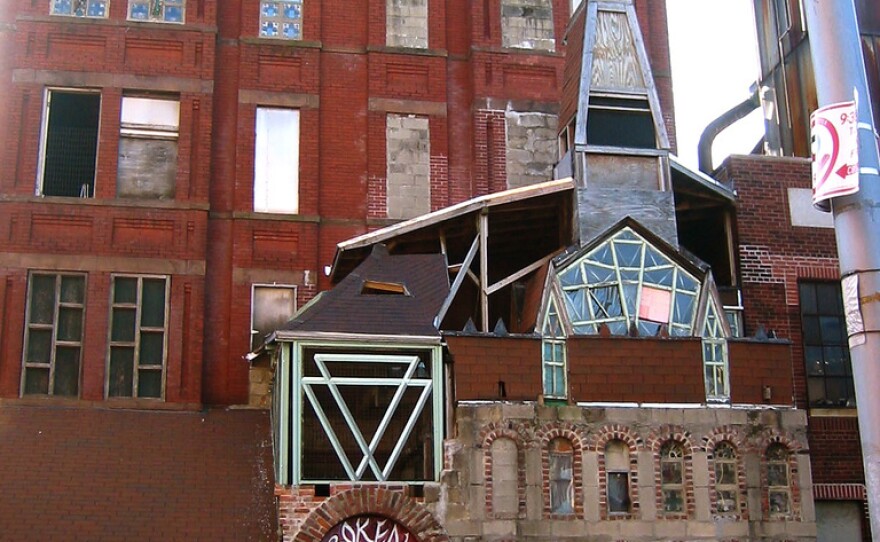 The building, which was featured in the film <em>Dave Chappelle's Block Party,</em> once towered nine stories over the street. Arthur took out most of the floors, creating a soaring open space with stained glass windows.<em> </em>