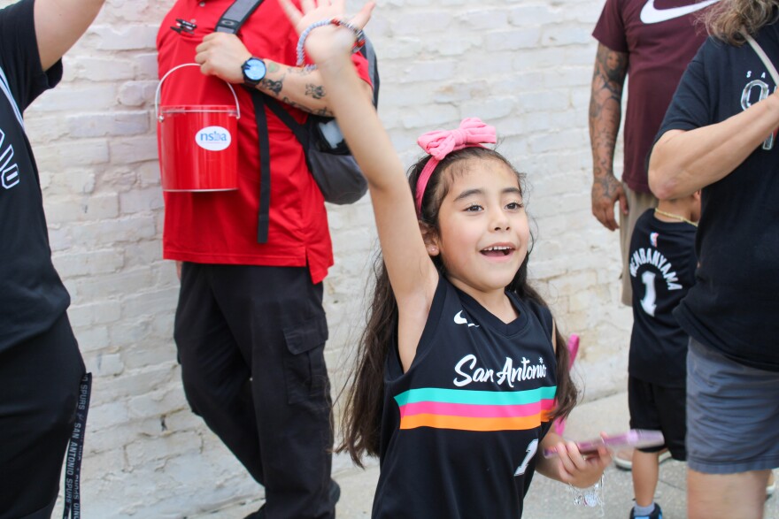 Mini superfan Rylee Sandoval cheers for the Spurs.