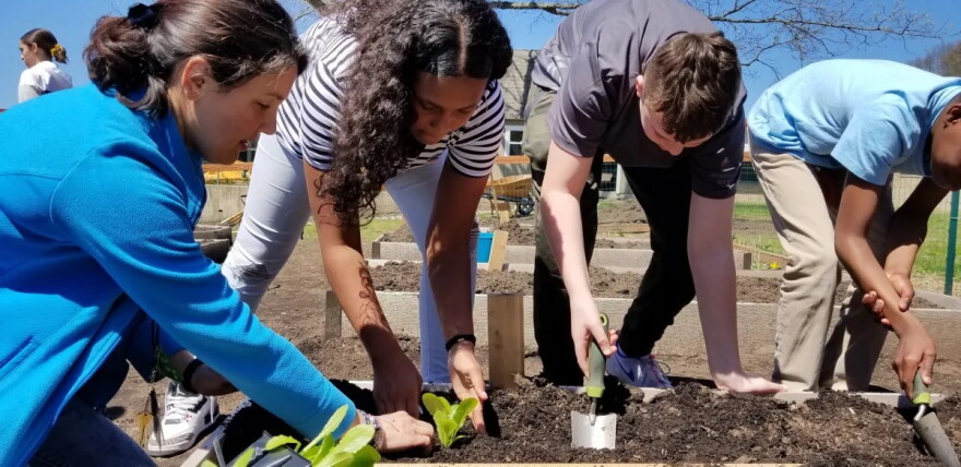 Katharine Bowers, left, was named 2024 Teacher of the Year by the Rhode Island Environmental Association. She helped establish a composting and food waste reduction program at the middle school where she teaches.
