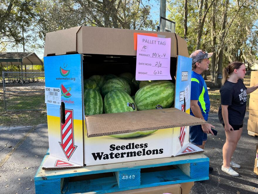 Fresh fruits and vegetables are passed out.