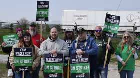 Dustin Dawson, in gray and Roy Spencer, beside Dawson, were among a group of workers picketing outside the ISU warehouse building north of campus.
