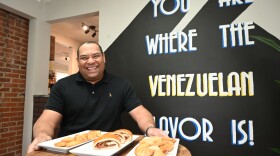 David Villanueva poses with Venezuelan foods at The Latin Corner in Pineville, North Carolina.