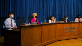 Members of the Leon County School Board preside over a meeting from a long dais. (Craig Moore/WFSU Public Media)