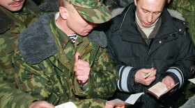 Then-acting Russian President Vladimir Putin signs autographs for Russian soldiers, east of the Chechen capital, Grozny, in January 2000. Putin, who took over office after President Boris Yeltsin resigned a day earlier, visited Russian forces in Chechnya to praise them for the campaign to crush separatist rebels.
