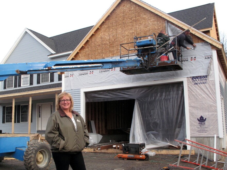 De Desharnais, a homebuilder and real estate agent in Nashua, N.H., stands in front of a house her company is constructing. She says her company had 32 employees at the height of the housing boom, and now only has six despite the industry's gradual recovery.