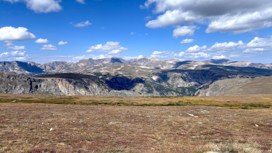 Photo of a series of mountain ranges from across a flat but high-elevation field.