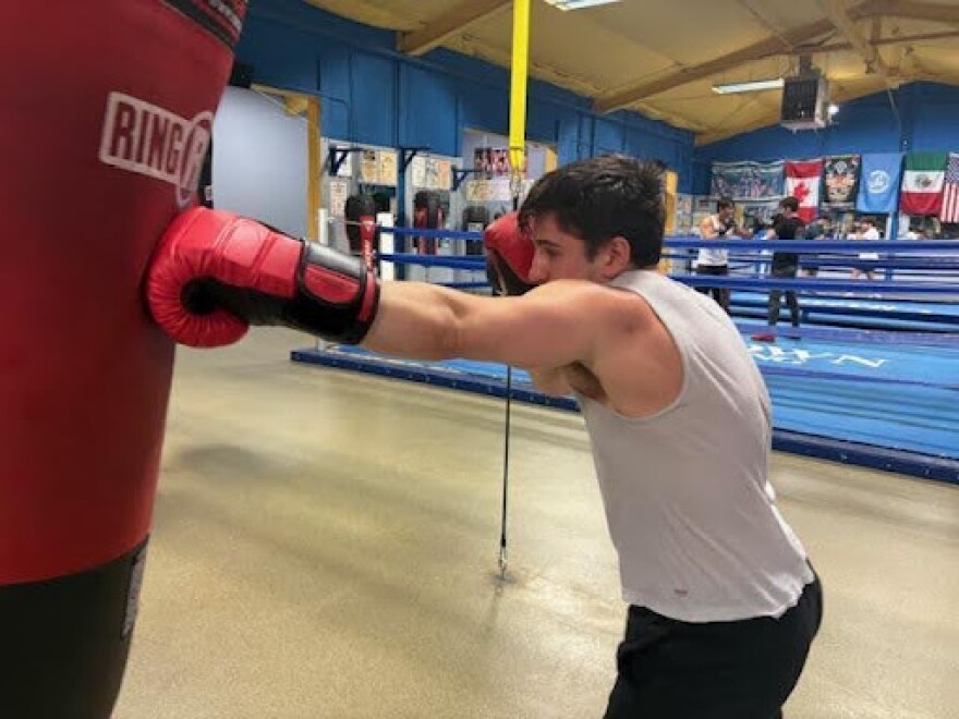 Alex Ziouras hammers the heavy bag with left jabs.