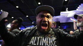 A Baltimore Ravens fan reacts to the team's first overall draft selection of guard Olaivavega Ioane during an NFL football draft party at M&T Bank Stadium in Baltimore, Thursday, April 23, 2026. (AP Photo/Stephanie Scarbrough)