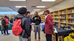 Kappa Alpha Psi member Michael Mashif White (right) speaks with students at Ypsilanti Community High School.