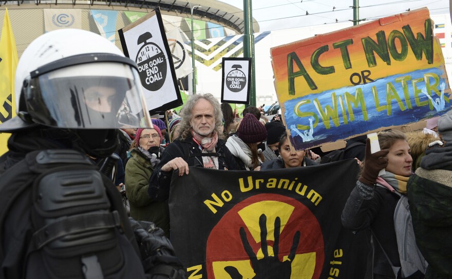 Climate activists stop in front of the COP24 UN Climate Change Conference venue during the March for Climate in a protest against global warming in Katowice, Poland, Saturday, Dec. 8, 2018.