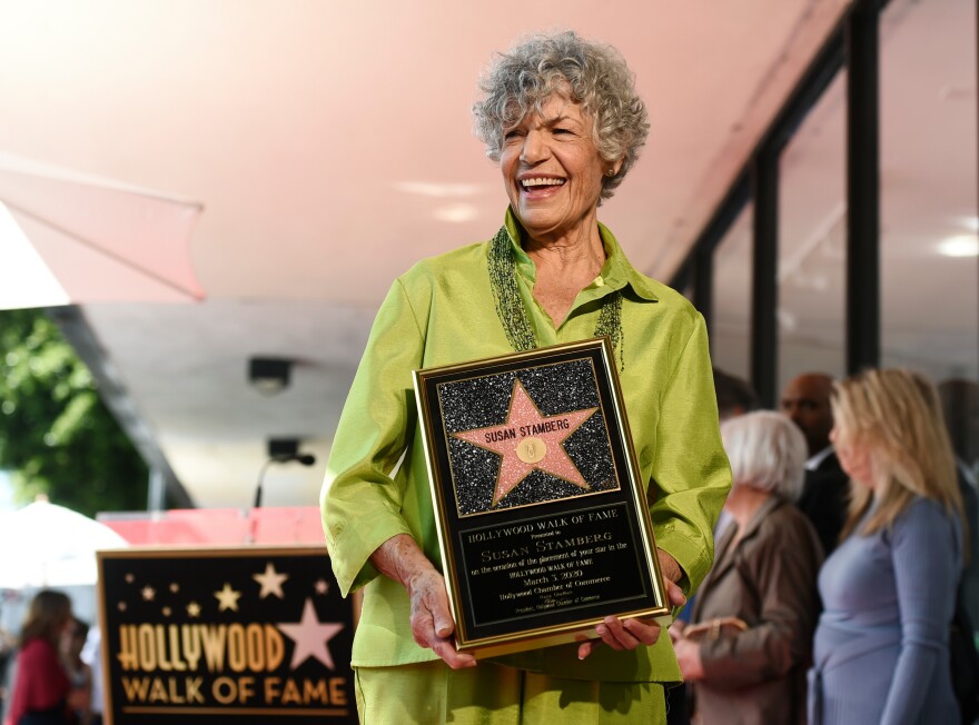 FILE - National Public Radio broadcast journalist Susan Stamberg holds up a replica of her new star on the Hollywood Walk of Fame following a ceremony, in Los Angeles, March 3, 2020. Stamberg, a ‘founding mother’ of NPR and the first female broadcaster to host a national news program, died Thursday, Oct. 16, 2025. She was 87. (AP Photo/Chris Pizzello, File)