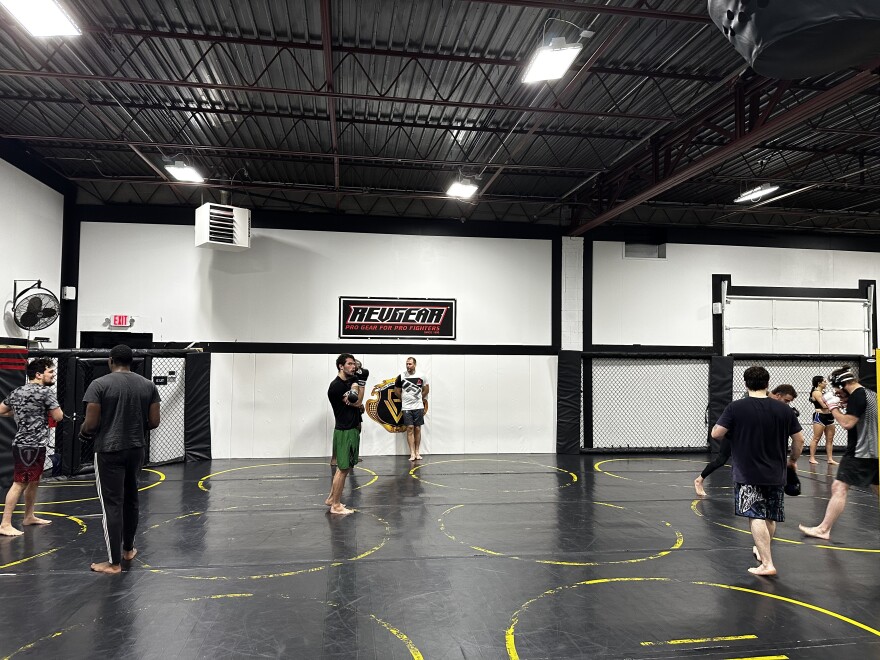 Instructor and former UFC fighter Zak Ottow stands against a wall before teaching a class at Pura Vida BJJ & MMA.