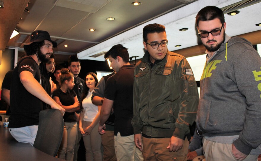 Students get a tour of the bus from on-board engineer Gabe Smith, left.