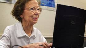 77-year-old Suzette D'Hooghe works on her laptop computer during a computer class in Des Plaines, Ill., in 2003. Increasing numbers of people older than 50 are turning to social networking to share updates and connect with family and friends.