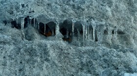 Icicles hang from inside a parking lot snow pile near the Twin Cities on Feb. 6, 2026.