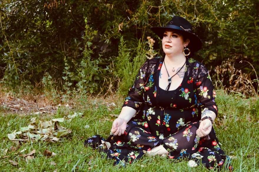 Naomi Ochoa sits in a park in Denver.