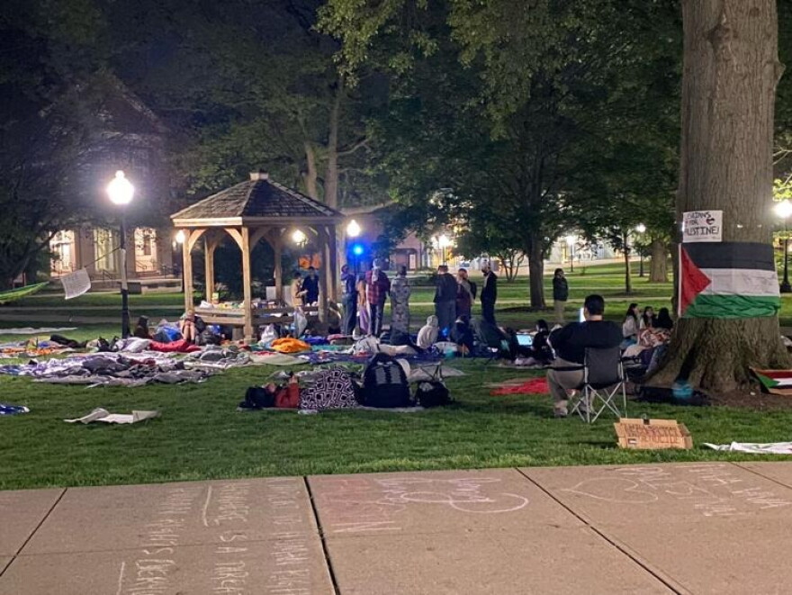 A nighttime view of the ISU Quad, showing people milling about as part of the demonstration