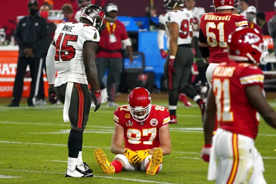 Kansas City Chiefs tight end Travis Kelce (87) sits on the field after an incomplete pass as Tampa Bay Buccaneers inside linebacker Devin White (45) looks on in the second half of the NFL Super Bowl 55 football game, Sunday, Feb. 7, 2021, in Tampa, Fla. (AP Photo/Gregory Bull)