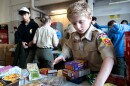 Scout Nate Thompson, 11, of Troop 21 sorts non-perishable food items for the annual Scouting for Food Good Turn drive. 