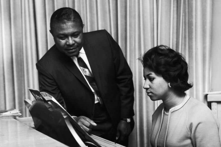 Aretha Franklin at the piano, with her father, the Reverend C.L. Franklin, in an undated photo.