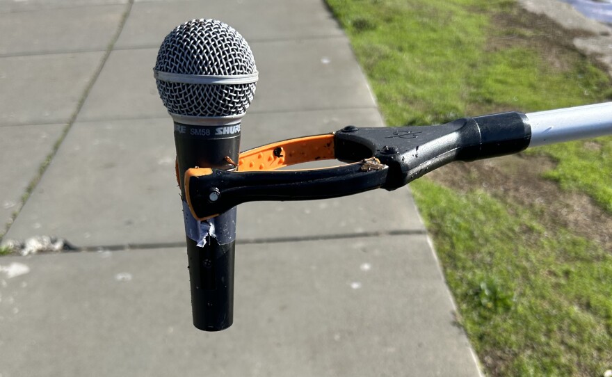 Trash Falcons pick up a microphone out of Lake Merritt using their grabbers.