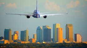 Passenger jet airliner plane arriving or departing Tampa International Airport in Florida at sunset or sunrise