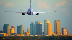 Passenger jet airliner plane arriving or departing Tampa International Airport in Florida at sunset or sunrise