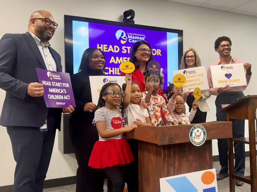 Congresswoman Tlaib and the speakers at Friday's press conference pose with children, holding signs supporting the Head Start program.