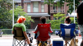 Protesters sit outside the N.C. Executive Mansion in Raleigh, N.C., Tuesday morning, June 30, 2020. They camped out overnight Monday to protest a new bill that further limits public access to death investigation records.