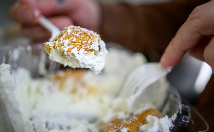 September 17, 2025 - Springfield, Ma. - Chion Wolf samples a cream puff made at The Big E. Cream puff maker Lynn McKenna who estimate making more than 100,000 cream puffs and 45,000 eclairs in a year said “People will wait for hours in a line to get a cream puff.” (Mark Mirko/Connecticut Public)