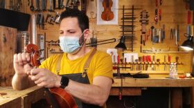 Luthier (violin maker) in his workshop