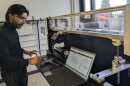 Dewasis Dahal works in an SIU lab to calibrate hydraulic experiments using a flume from Little River Research & Design.